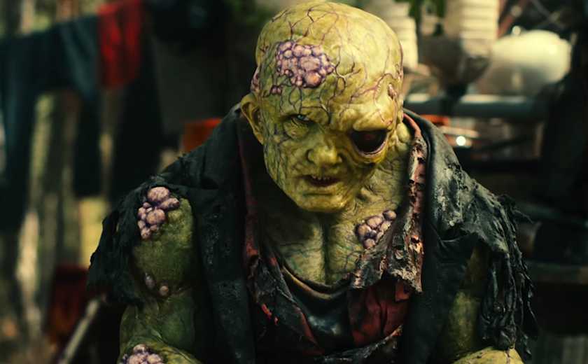 Toxie (Peter Dinklage), a mutated, green-skinned, bulging creature with one giant black eye and a skull-like head, in the 2025 Toxic Avenger